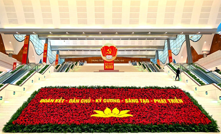 Một thảm hoa lớn với dòng chữ “Đoàn kết - Dân chủ - Kỷ cương - Sáng tạo - Phát triển” đươc trang hoàng trước Hội trường Trung tâm Hội nghị Quốc gia