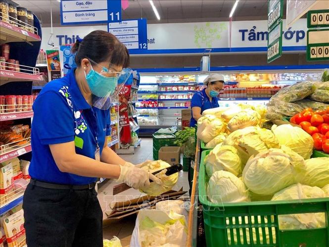 Nhân viên siêu thị TP Hồ Chí Minh bổ sung hàng hóa lên kệ phục vụ khách hàng mua sắm trực tiếp