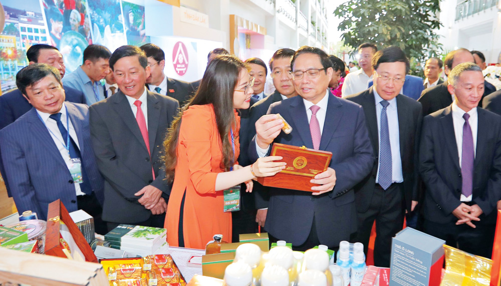Thủ tướng Phạm Minh Chính cùng lãnh đạo bộ, ngành và địa phương tham quan gian hàng trưng bày sản phẩm tiêu biểu Tây Nguyên. Ảnh: Chính Thành