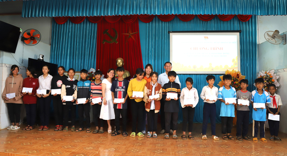 Đại diện doanh nghiệp và Chi đoàn Báo Lâm Đồng trao học bổng cho các em học sinh