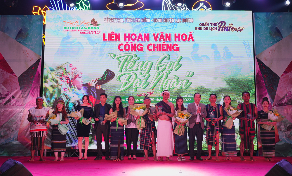 Chủ tịch UBND huyện Lạc Dương Sử Thanh Hoài tặng hoa và biểu trưng cho các đoàn nghệ nhân