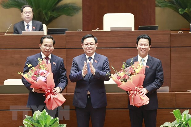 Chủ tịch Quốc hội Vương Đình Huệ chúc mừng tân Chủ nhiệm Ủy ban Tài chính-Ngân sách của Quốc hội Lê Quang Mạnh (bên trái) và tân Bộ trưởng Bộ Tài nguyên và Môi trường Đặng Quốc Khánh (bên phải), nhiệm kỳ 2021-2026