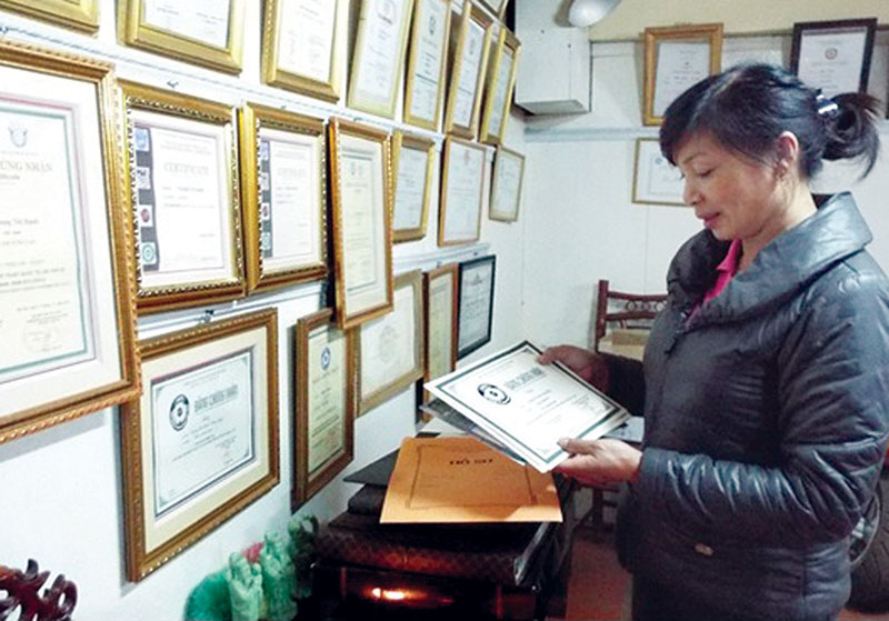 Chị Trương Thị Hạnh bên bộ sưu tập thành tích của cả hai vợ chồng
