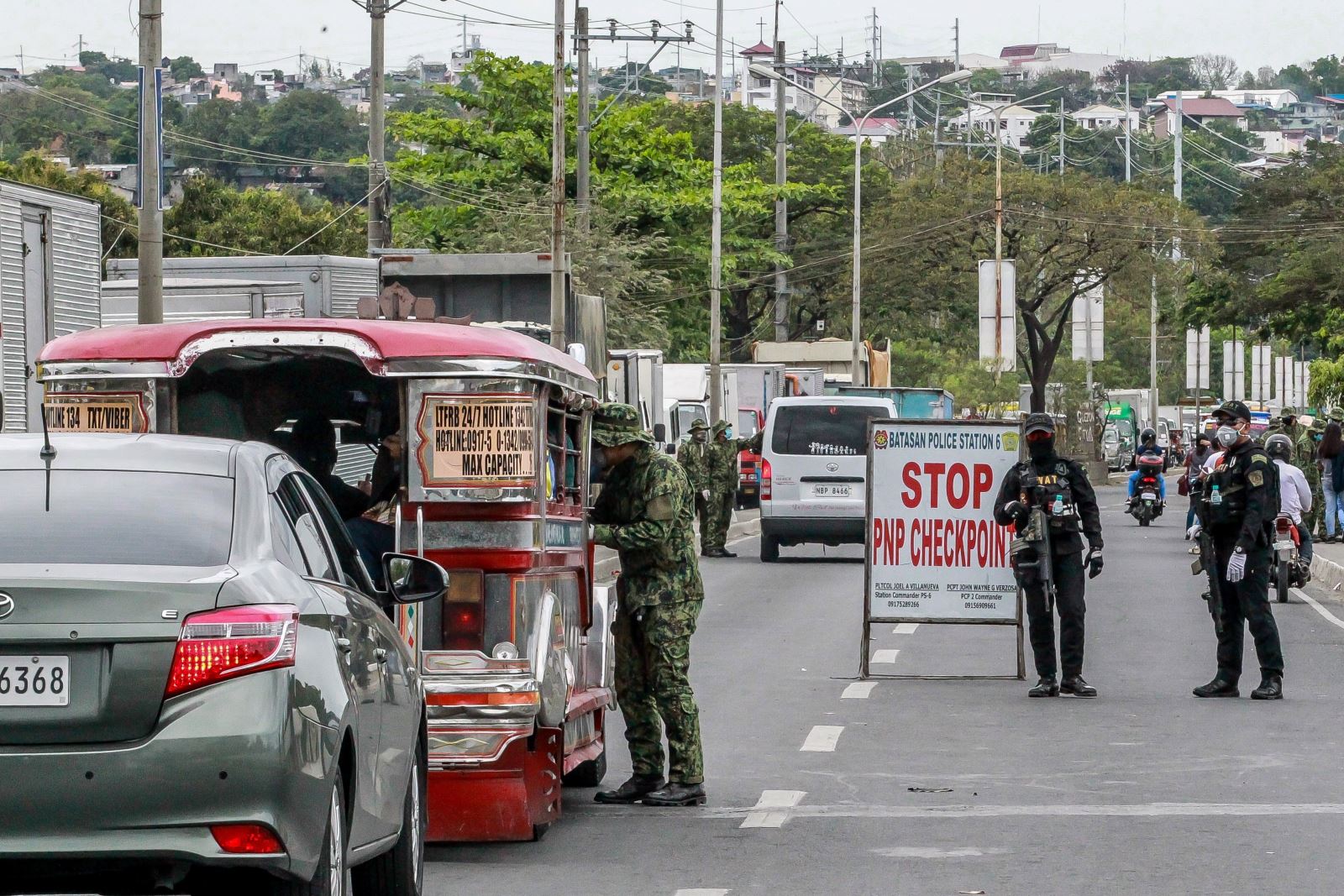 Cảnh sát kiểm tra thân nhiệt của người dân tại một điểm kiểm soát ở Quezon, Philippines ngày 16/3/2020, nhằm ngăn chặn sự lây lan của COVID-19