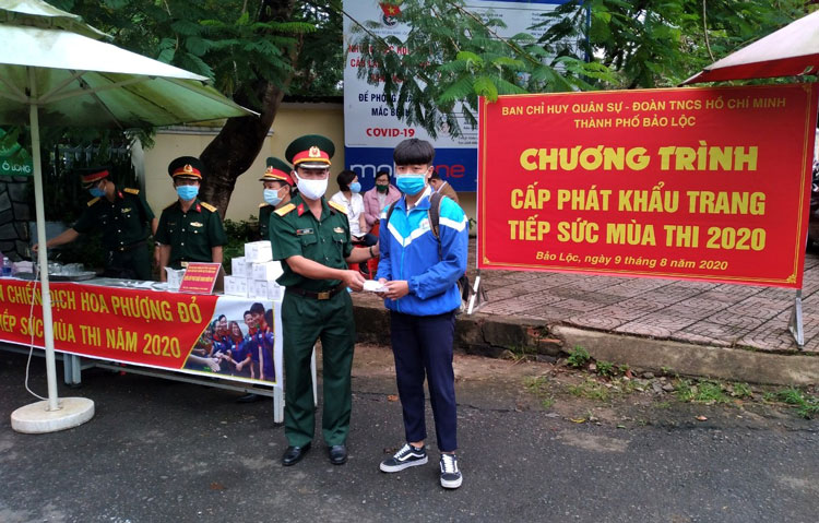 Lực lượng quân đội phát khẩu trang cho thí sinh tại điểm Trường THPT Nguyễn Du, Bảo Lộc. Ảnh:  Khánh Phúc