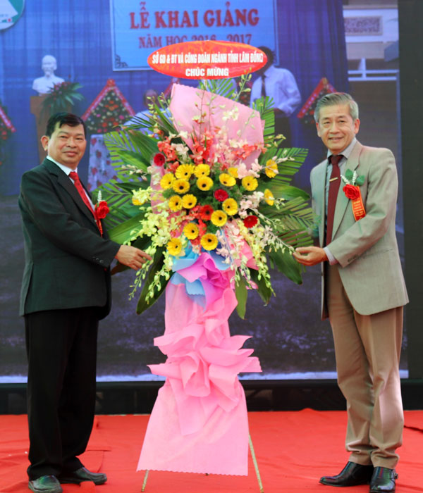 Ông Huỳnh Quang Long - Phó Giám đốc Sở Giáo dục và Đào tạo (GD&ĐT) tỉnh Lâm Đồng tặng hoa chúc mừng tại buổi lễ