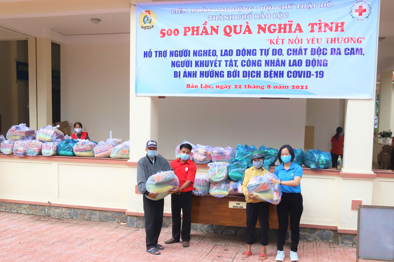 Đại diện Liên đoàn Lao động TP Bảo Lộc và Hội Chữ thập đỏ thành phố trao tặng quà cho các hoàn cảnh khó khăn