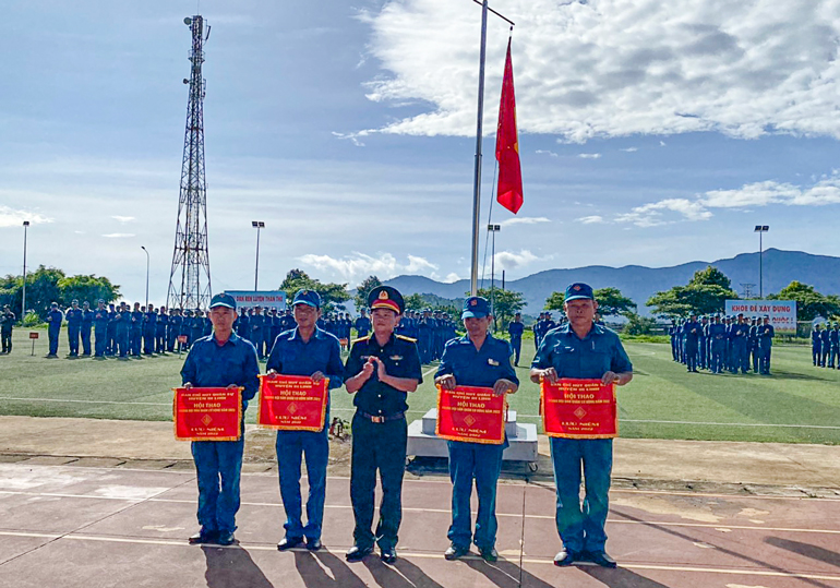Thiếu tá Trần Thanh Minh - Chỉ huy trưởng Ban Chỉ huy Quân sự huyện Di Linh trao cờ cho đại diện các cụm thi đua