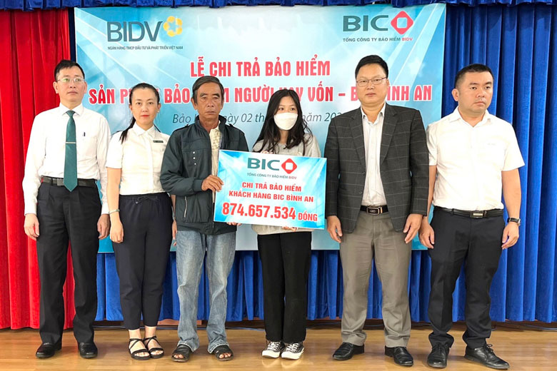Đại diện lãnh đạo BIC và BIDV Chi nhánh Bảo Lộc trao tiền bảo hiểm cho gia đình khách hàng