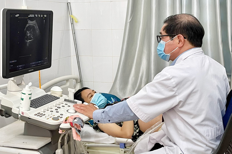 BS Nguyễn Văn Ninh - Trưởng Phòng khám Đa khoa khu vực Tân Hà (Lâm Hà) đang siêu âm theo dõi sức khỏe của thai nhi