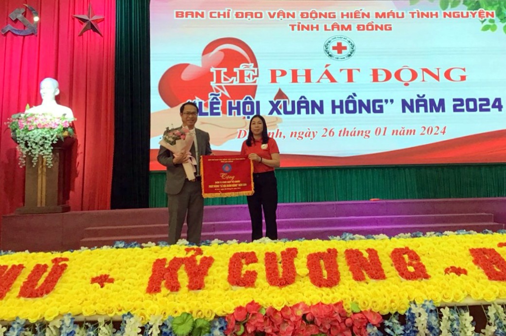 Bà Nguyễn Thị Hà –Phó Chủ tịch Hội Chữ thập đỏ tỉnh Lâm Đồng tặng cờ lưu niệm cho lãnh đạo huyện Di Linh, đơn vị phối hợp tổ chức lễ phát động Lễ hội Xuân hồng năm 2024
