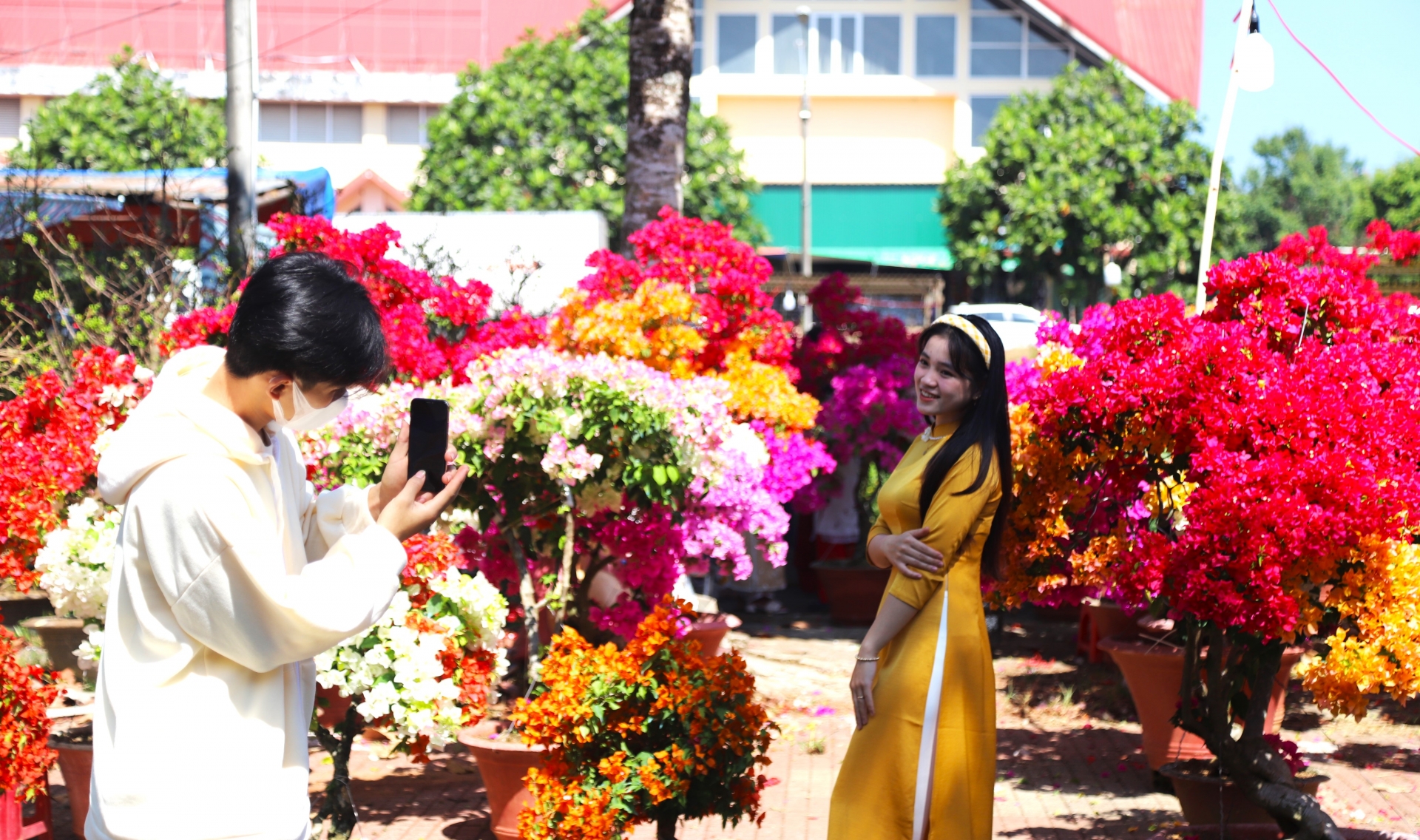 Các bạn trẻ tìm đến chợ hoa xuân vui chơi, chụp hình tạo thêm không khí vui tươi, nhọn nhịp tại các chợ hoa xuân