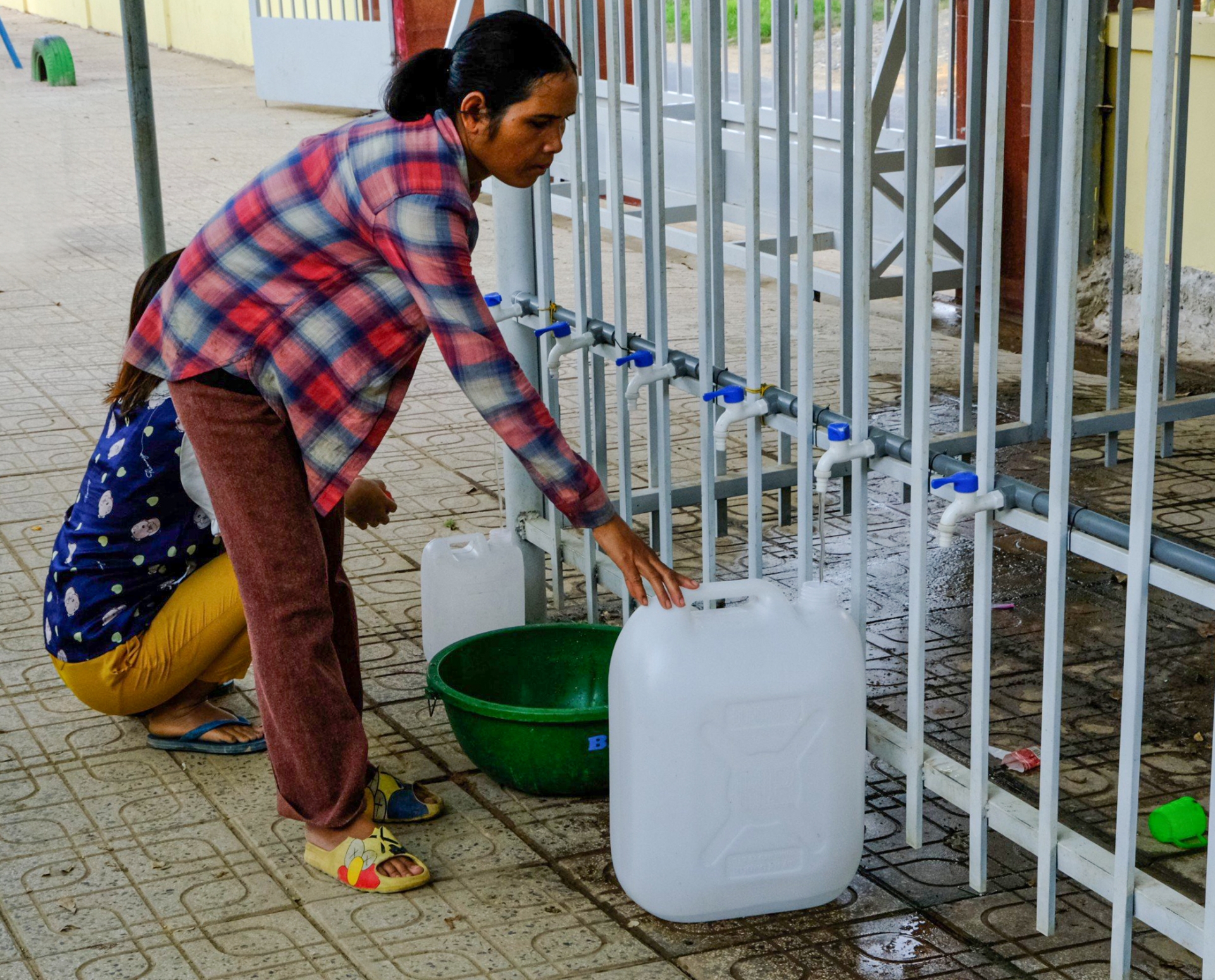 Do giếng đào của gia đình đã cạn, hàng ngày chị Ka Hội (Thôn 3, xã Lộc Bảo) mang theo can nhựa tìm đến phân hiệu Trường Tiểu học lấy nước về ăn uống