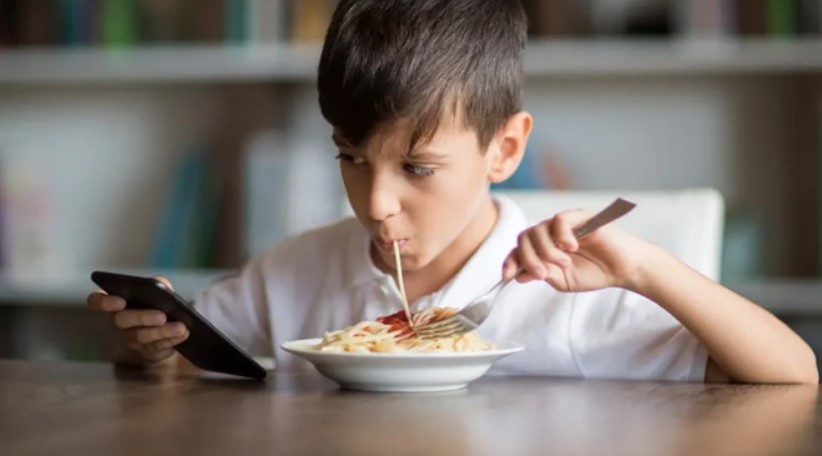 Vừa ăn vừa xem điện thoại khiến trẻ bị xao lãng, ăn nhiều hơn nhu cầu