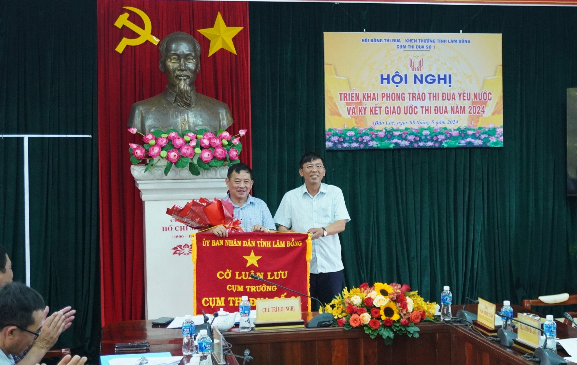 Ông Nguyễn Văn Phương - Chủ tịch UBND TP Bảo Lộc nhận Cờ luân lưu Cụm trưởng năm 2024 từ đại diện UBND huyện Di Linh