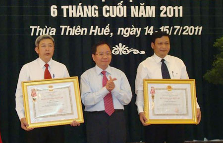 Ông Nguyễn Trọng Thoan - Cục trưởng Cục Thuế Lâm Đồng (bên trái) đại diện đơn vị đón nhận Huân chương Độc lập hạng 3.