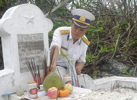 Trung úy Nguyễn Quang Trọng thắp hương cho đồng đội nằm lại trên đảo TS lớn.