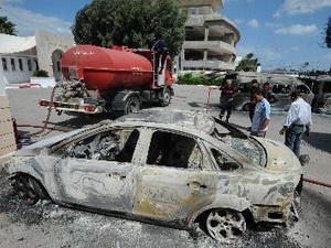 Chiếc xe bị phá hủy tại trường học của Mỹ ở thủ đô Tunis, Tunisia ngày 14/9. (Ảnh: AFP/TTXVN)