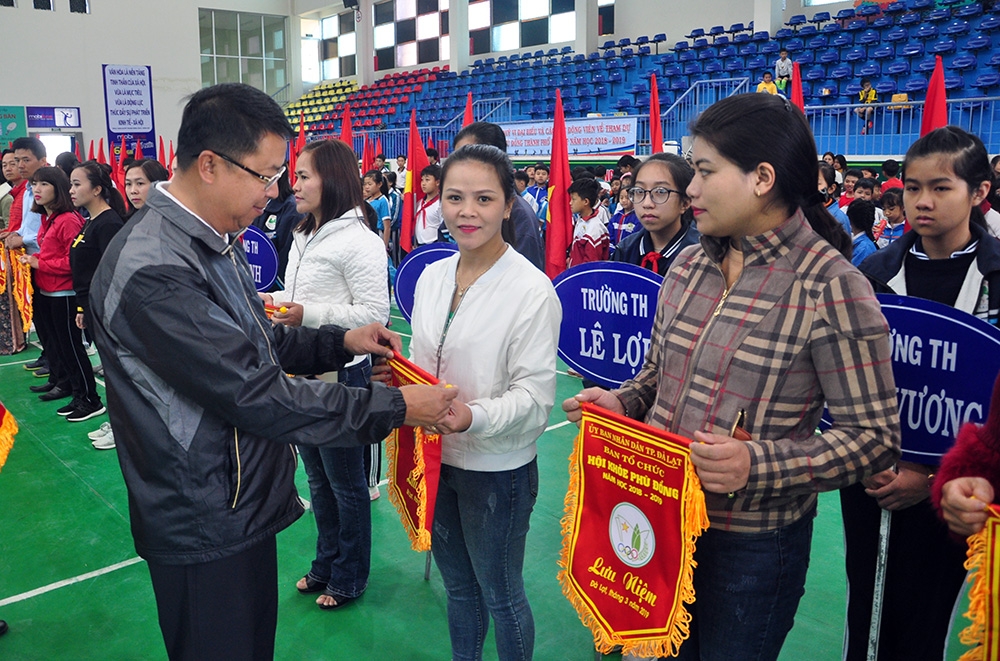 Ông Tôn Thiện San, Chủ tịch UBND thành phố Đà Lạt trao cờ lưu niện cho các trường tại lễ khai mạc  