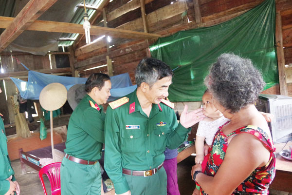 15 năm gắn bó với Đoàn KTQP là chừng ấy thời gian Đại tá Nguyễn Văn Minh - Đoàn trưởng Đoàn KTQP (bìa phải) và anh em trong đơn vị gắn bó với bà con.