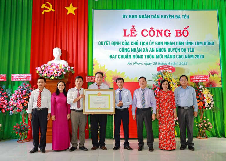 Lãnh đạo huyện Đạ Tẻh tặng hoa chúc mừng tại lễ công bố xã đạt chuẩn nông thôn mới nâng cao của xã An Nhơn